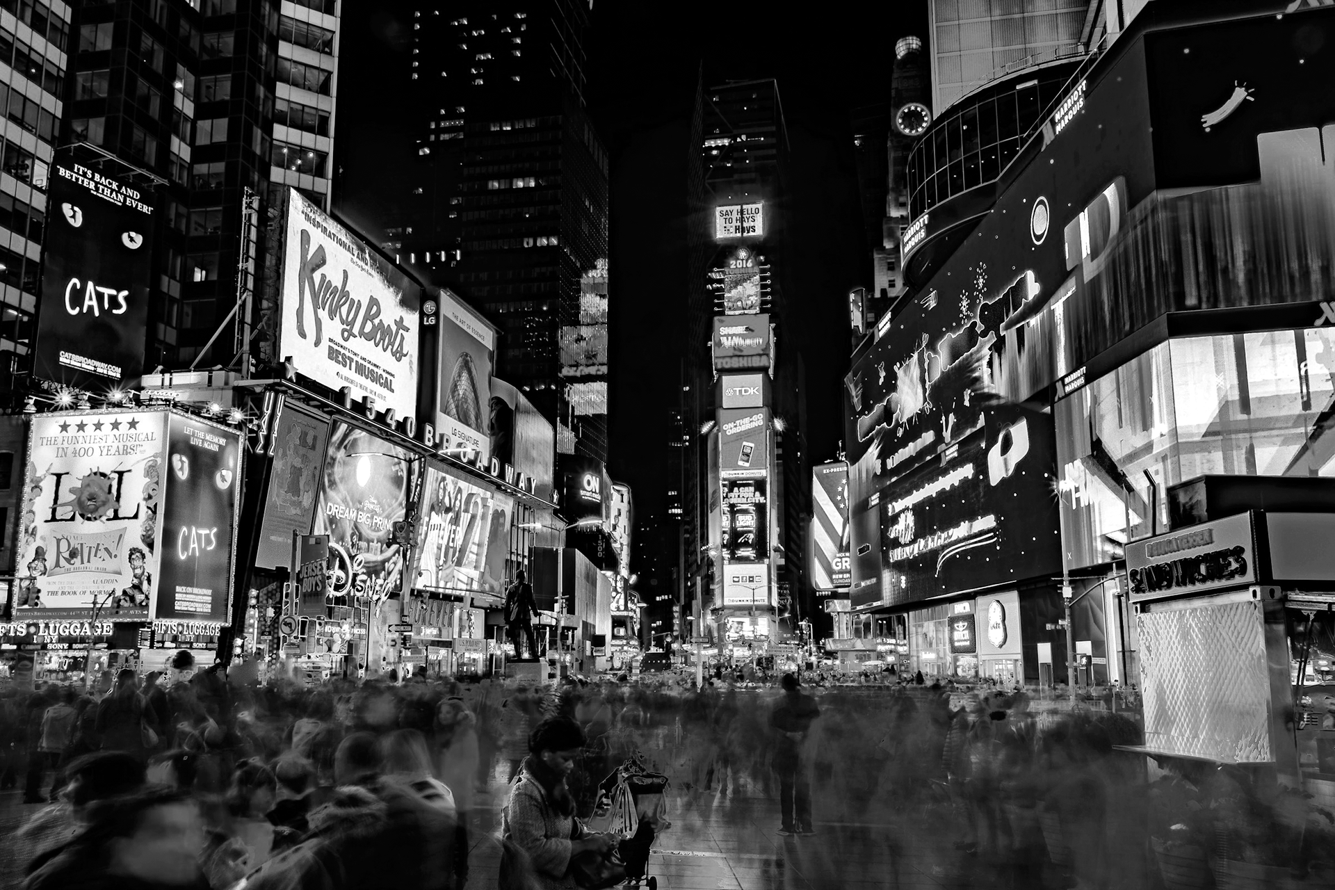 A sea of people under the Times Square ads and lights in New York City.